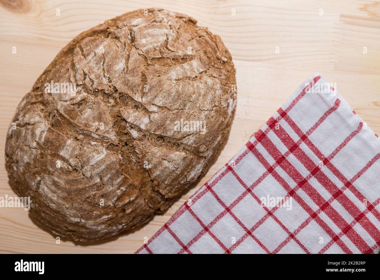 fresh farmer's bread with tea towel - bread crust of sourdough bread Stock Photo