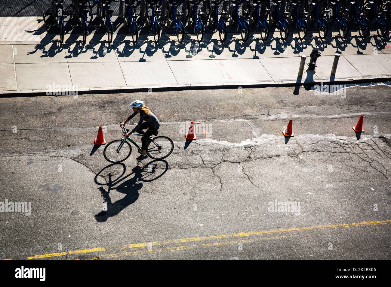 New York City street with rental bikes and a cyclist on the road see from above Stock Photo