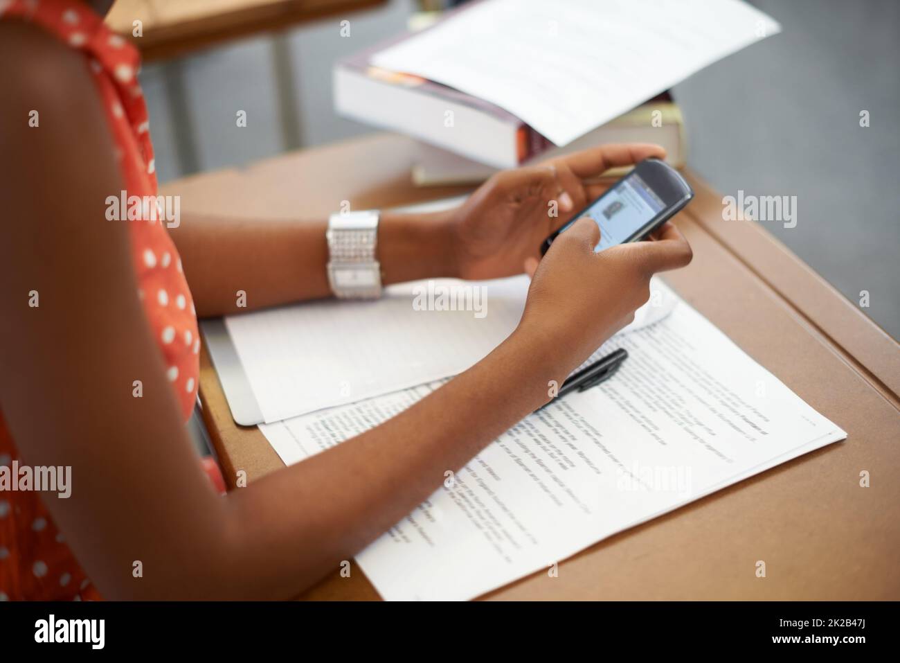 Youll learn nothing if you take shortcuts. A student using the internet to cheat on her exam. Stock Photo