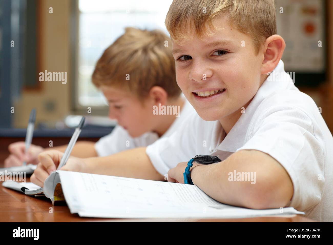 Enjoying his learning experience. Two young schoolboys doing their