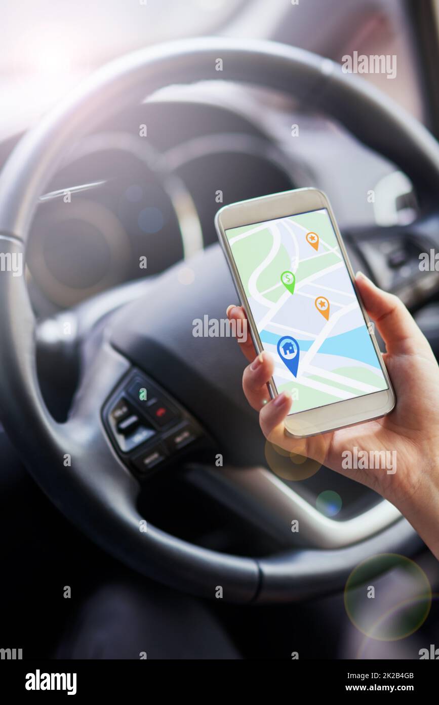 Navigation made easy. Shot of a person in a car using their phone to