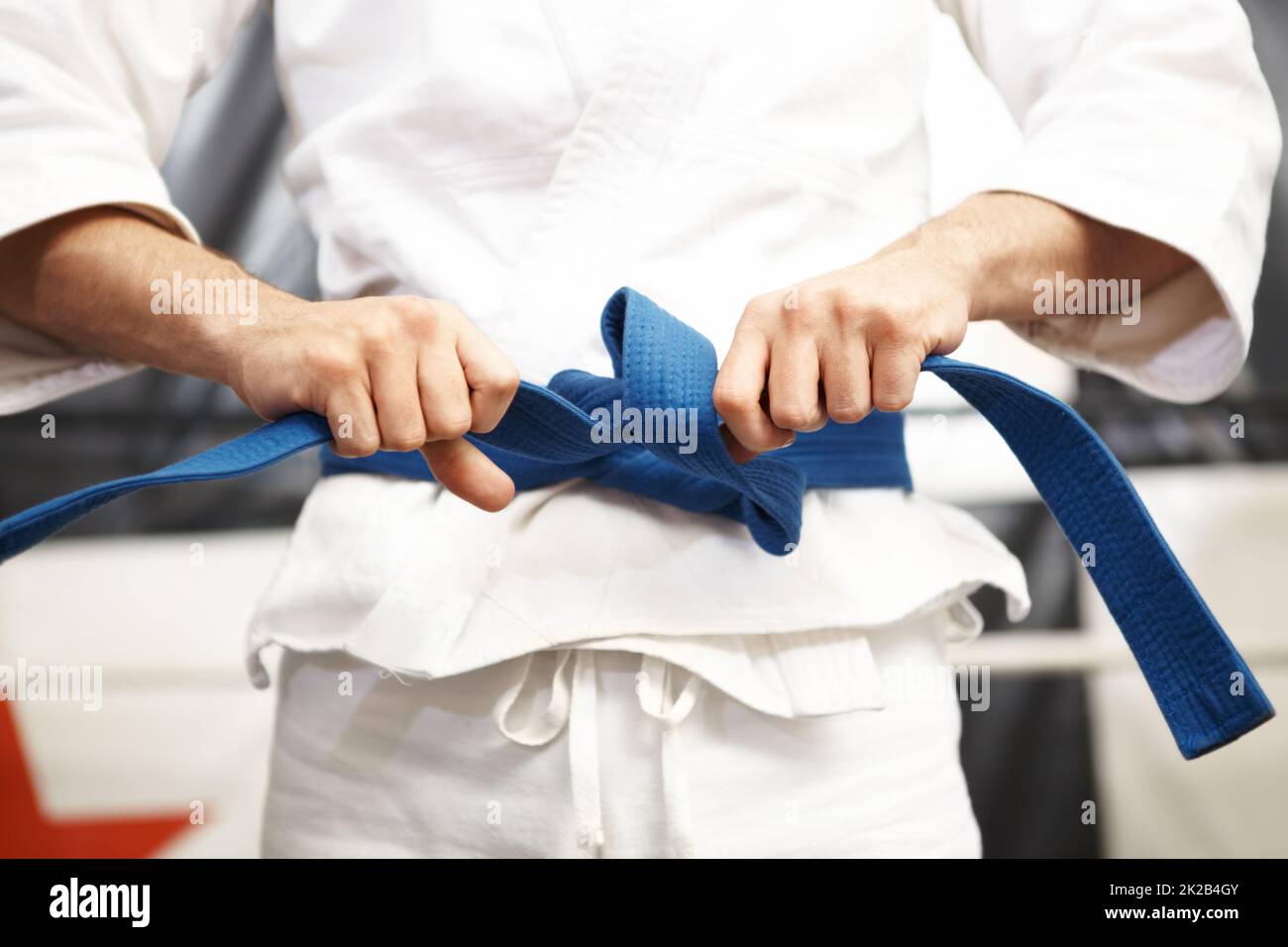 Preparing for battle. Cropped shot of martial artist putting on his gi