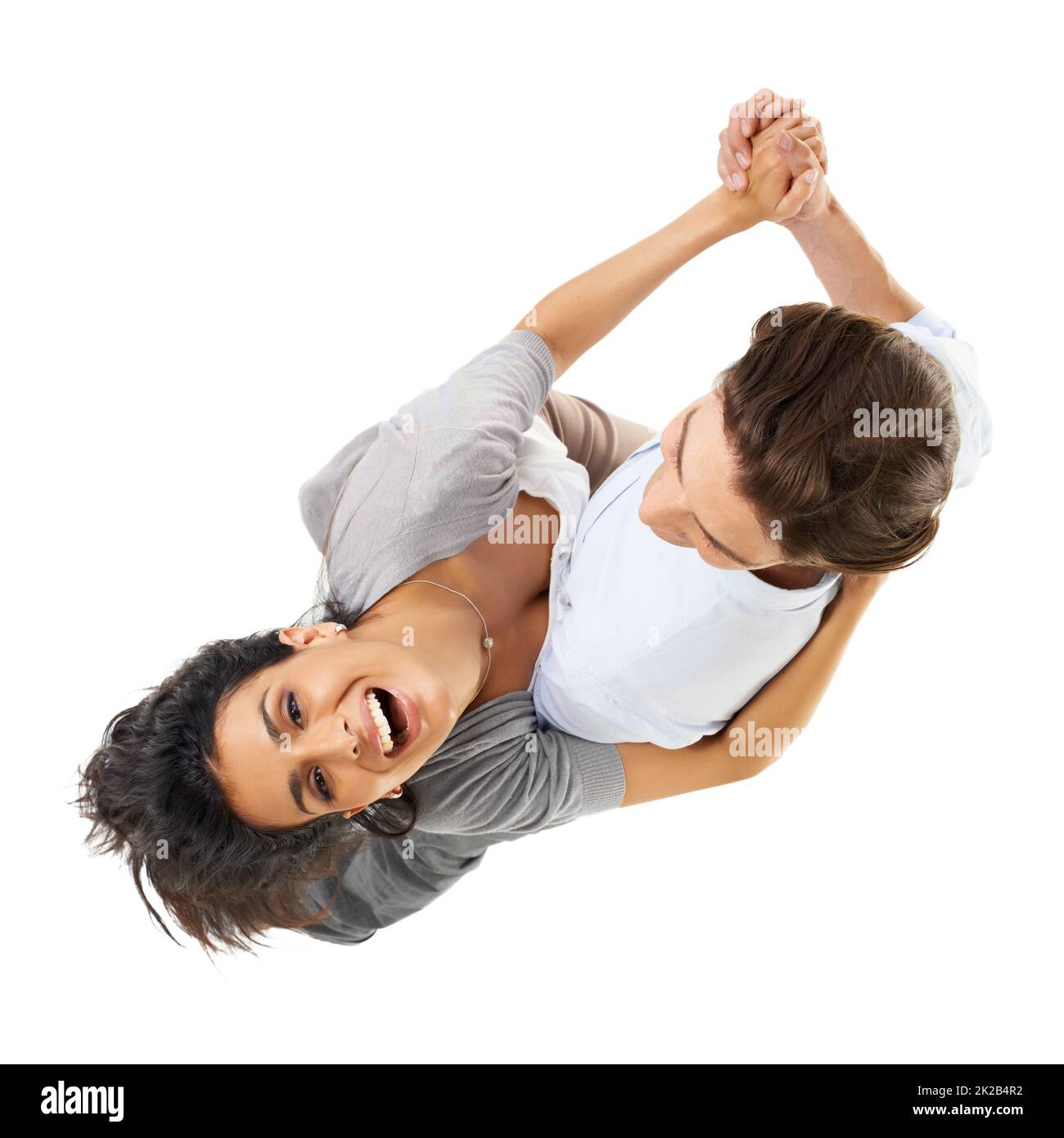 He know how to blow her away. A multi-ethnic couple dancing isolated on a white background - high angle view. Stock Photo