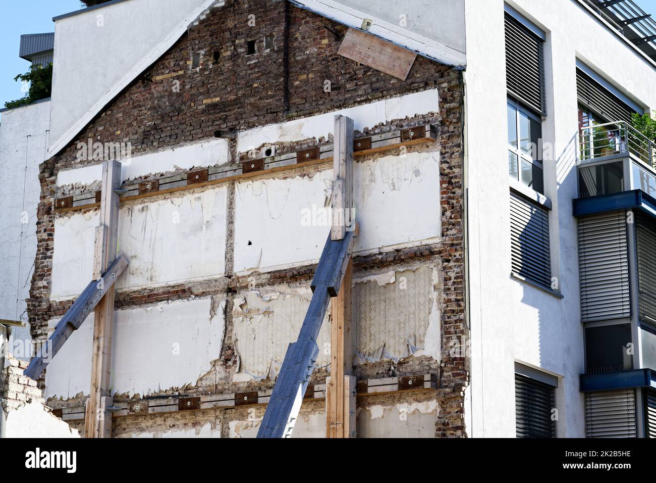 Support of a building wall with wooden struts after demolition of an old building Stock Photo