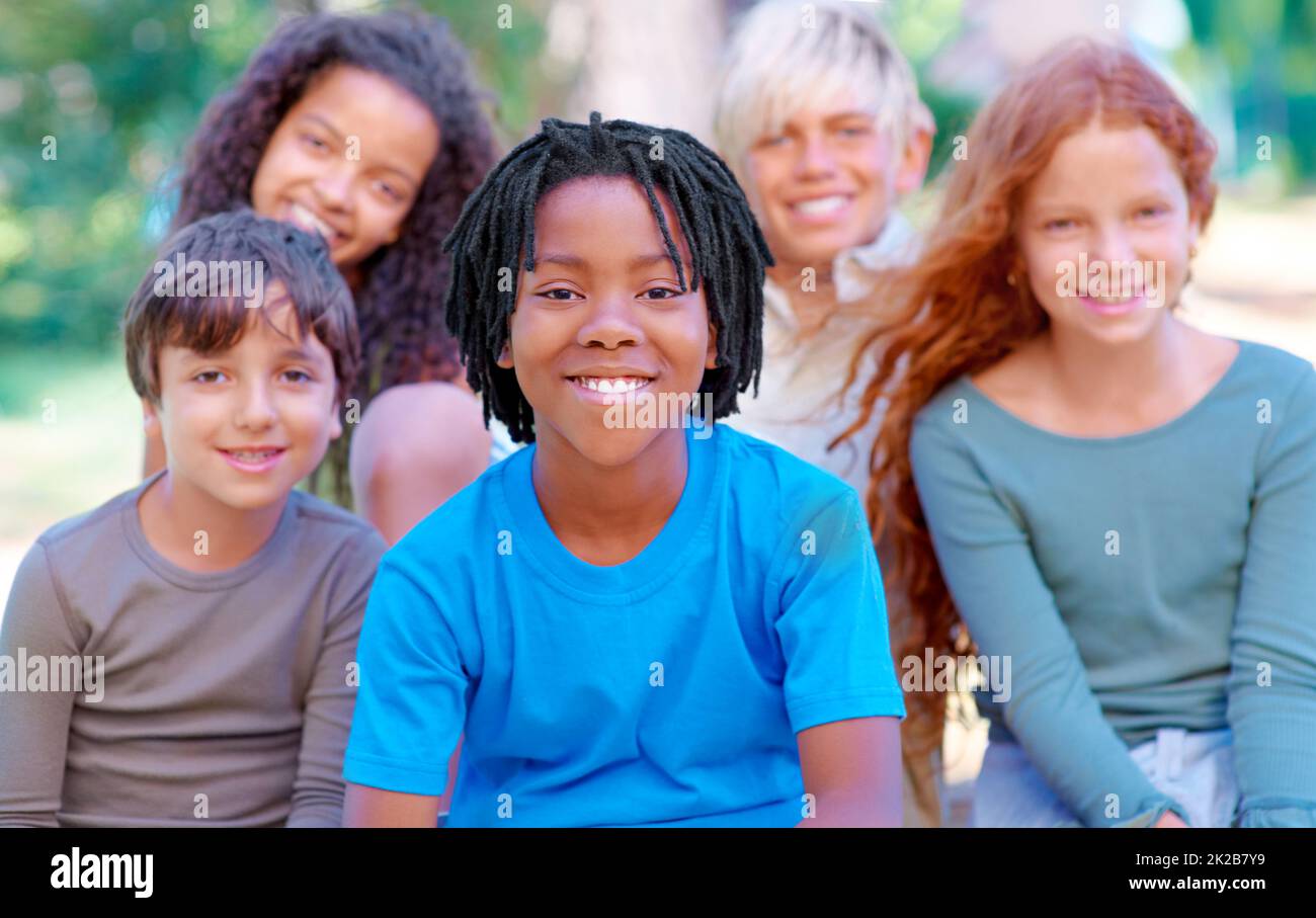 They are our future. A group of children smiling at the camera in the outdoors. Stock Photo