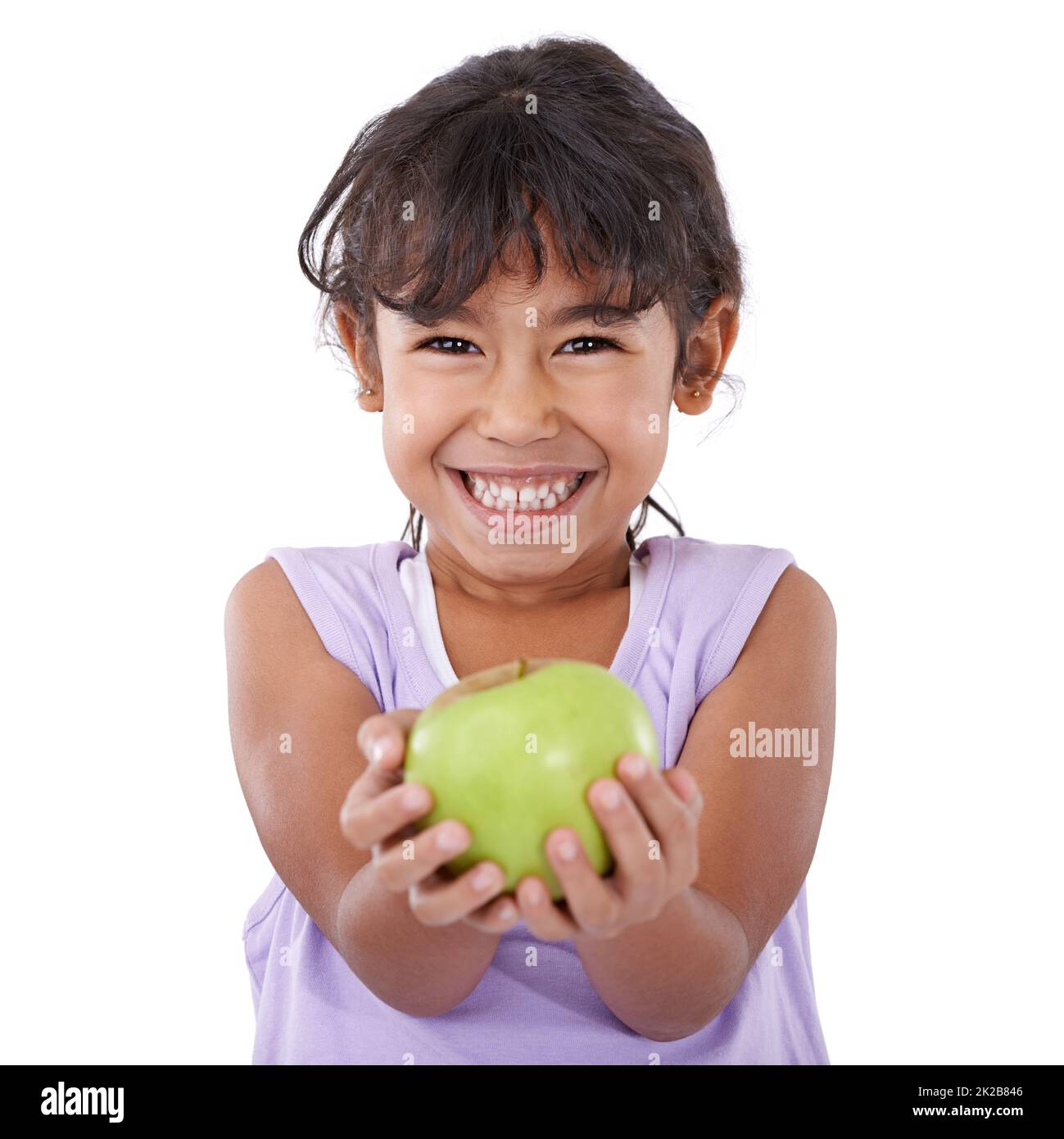 Mom says this will keep me strong and healthy. Portrait of an adorable little girl smiling and holding an apple. Stock Photo