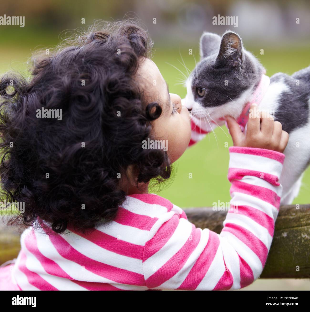 Shes my best friend. Shot of a cute little girl kissing her kitten. Stock Photo