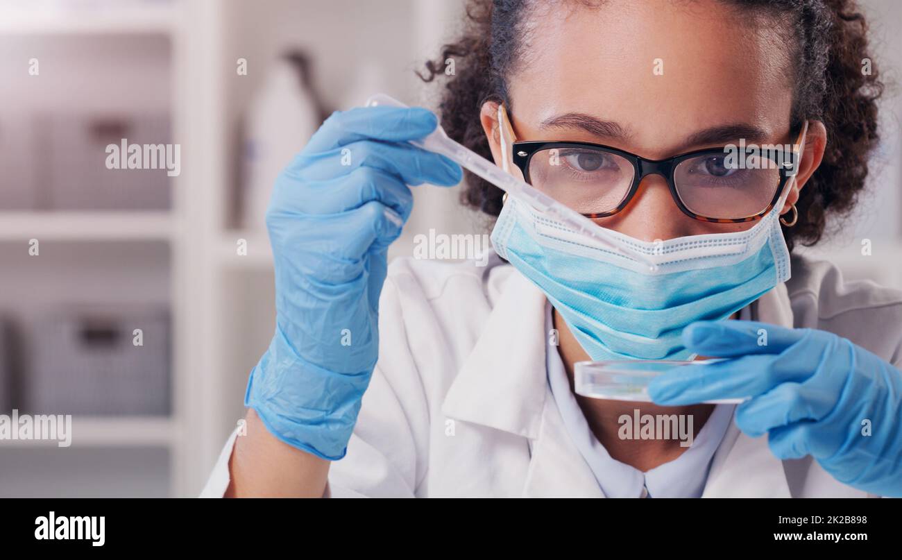 This test should do it. Shot of a young scientist analysing samples in a lab. Stock Photo