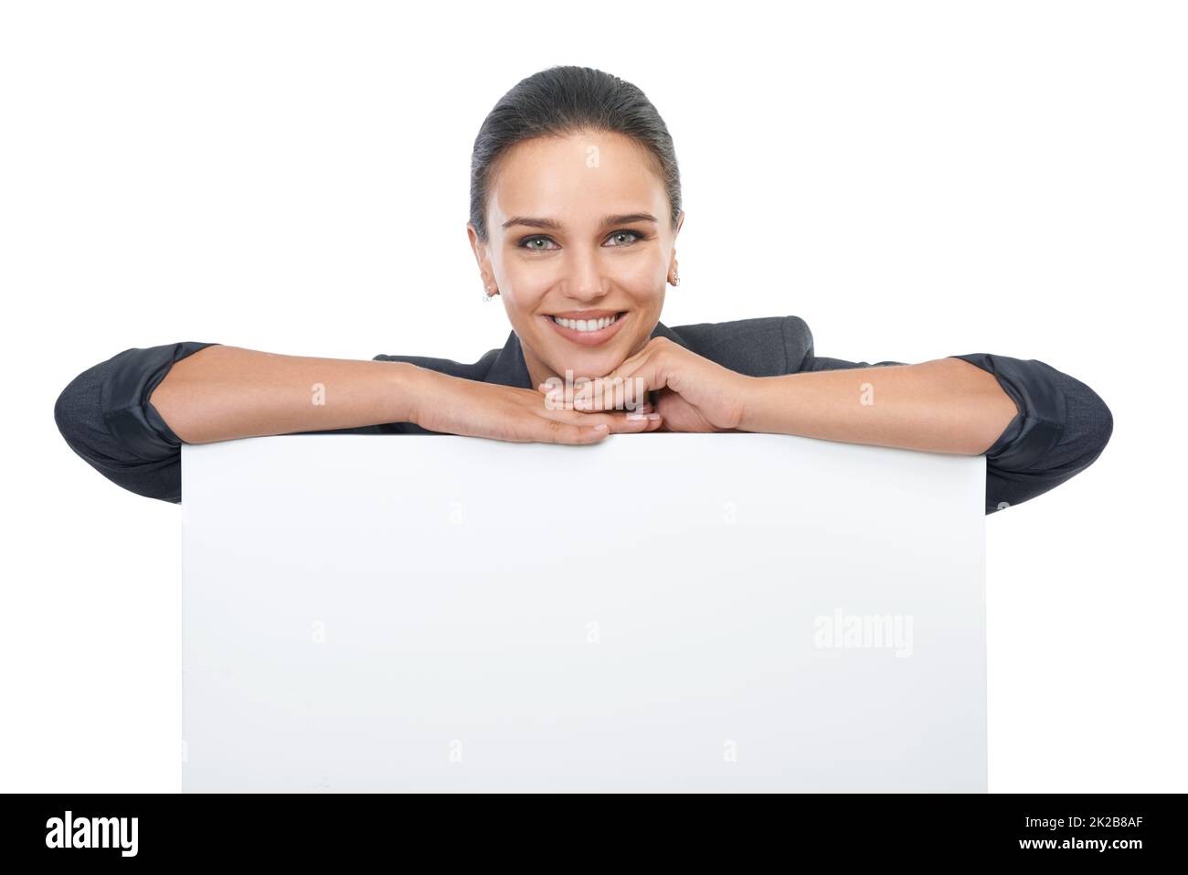 Looking for new business ideas. Studio shot of an attractive young businesswoman holding a blank placard for copyspace. Stock Photo