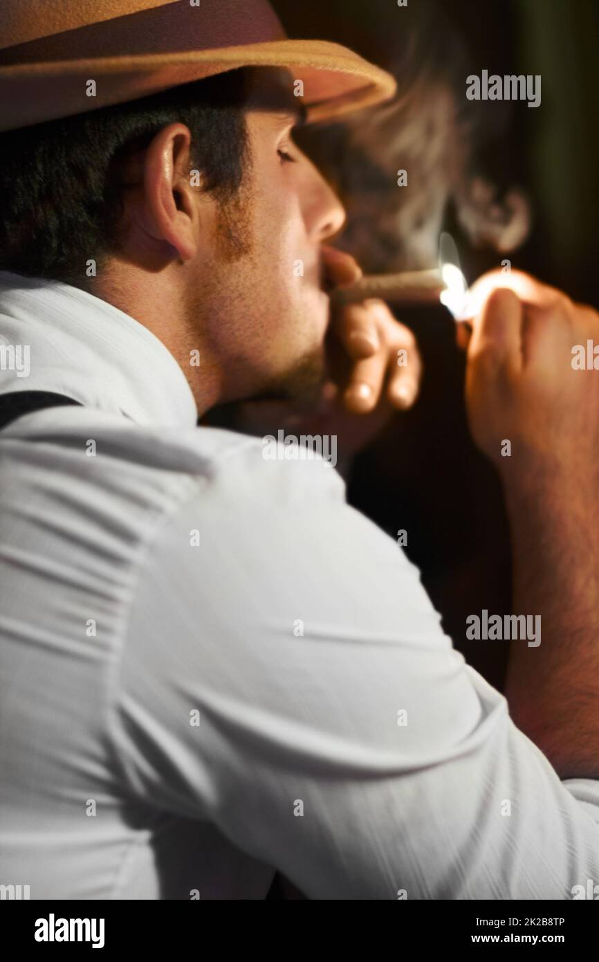 Smooth criminal. Smooth crime boss lighting up a cigar rear view