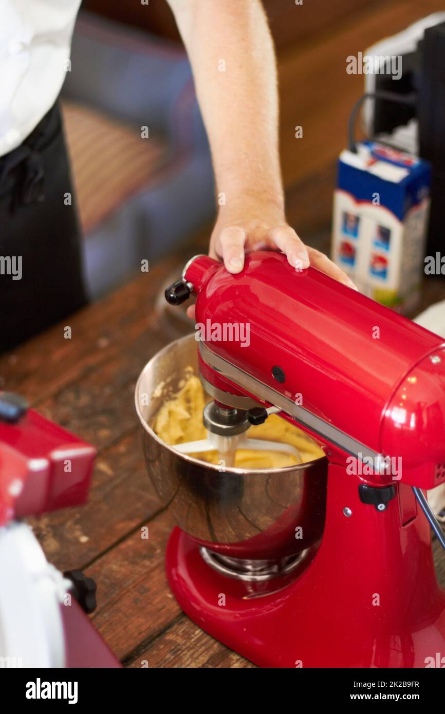 White kitchen machine and stand mixer on a wooden table in a bright design  apartment Stock Photo - Alamy