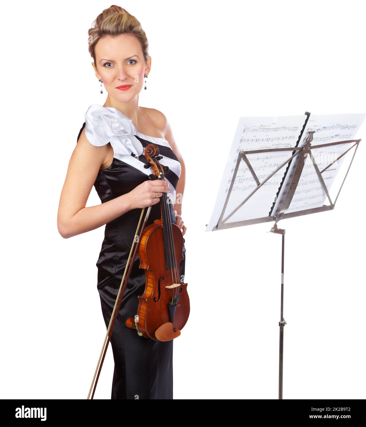 Beauty and baroque. A violinist standing in front of a sheet