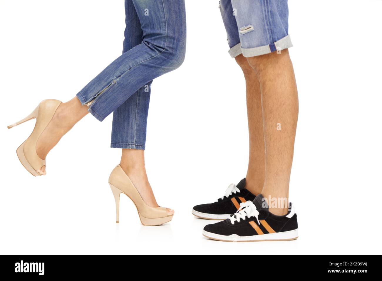 So in love.... Cropped image of a man and womans feet as they stand together in a romantic pose. Stock Photo