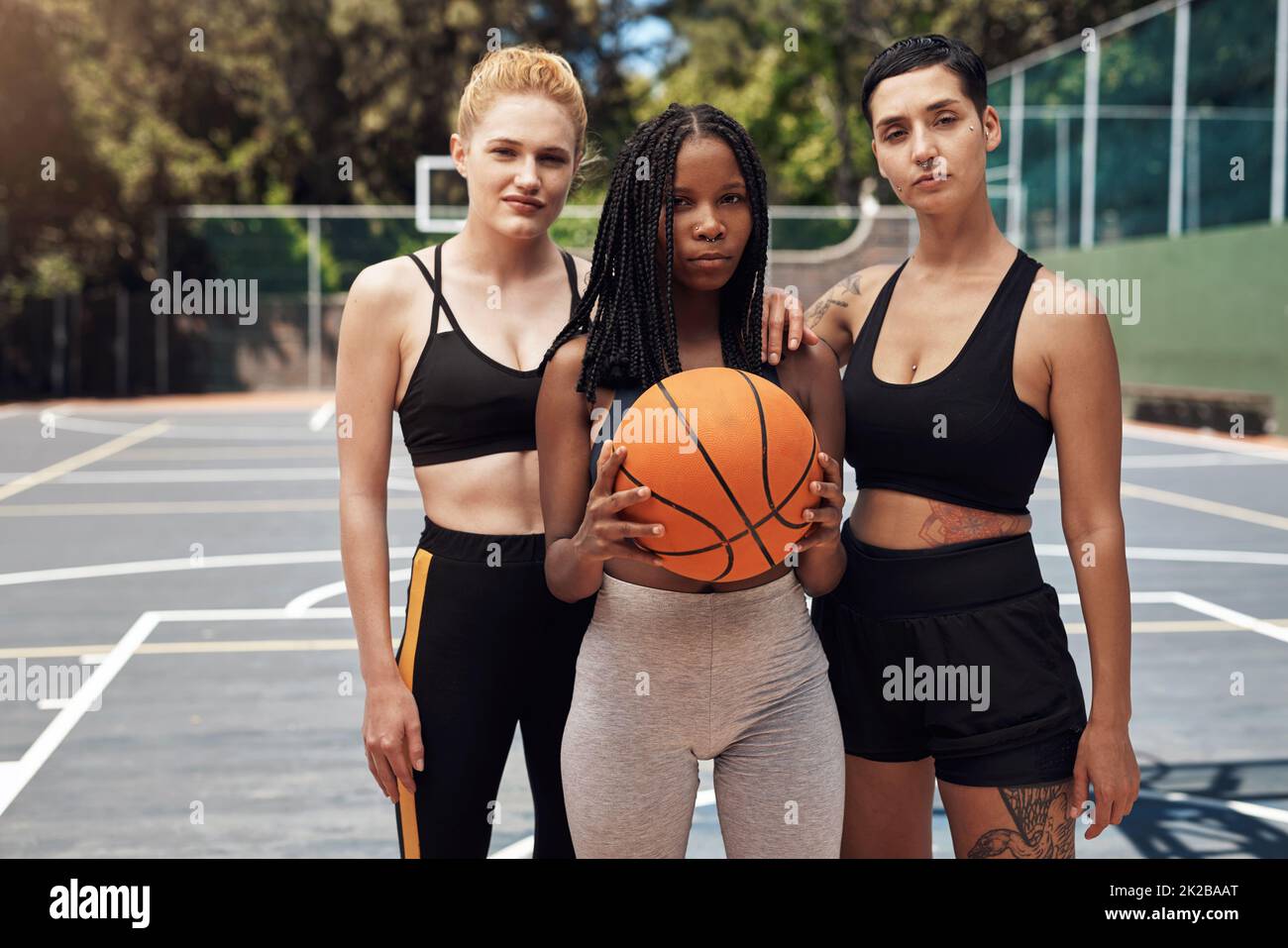 Winners dont wait for chances, they take them. Portrait of a group of sporty young women standing together on a sports court. Stock Photo