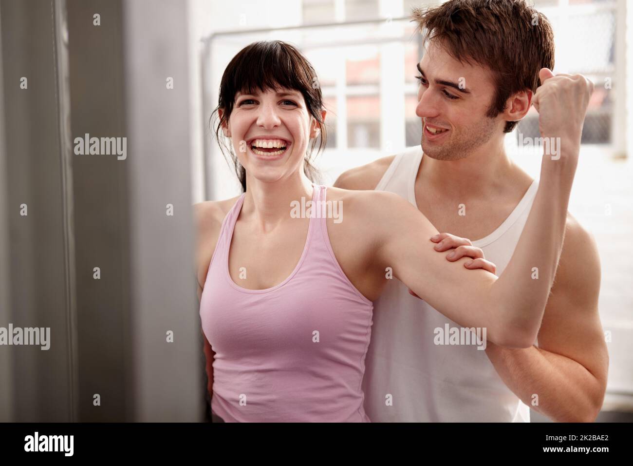 Start working towards your fitness goals. Shot of an attractive young woman being assessed by a personal trainer. Stock Photo