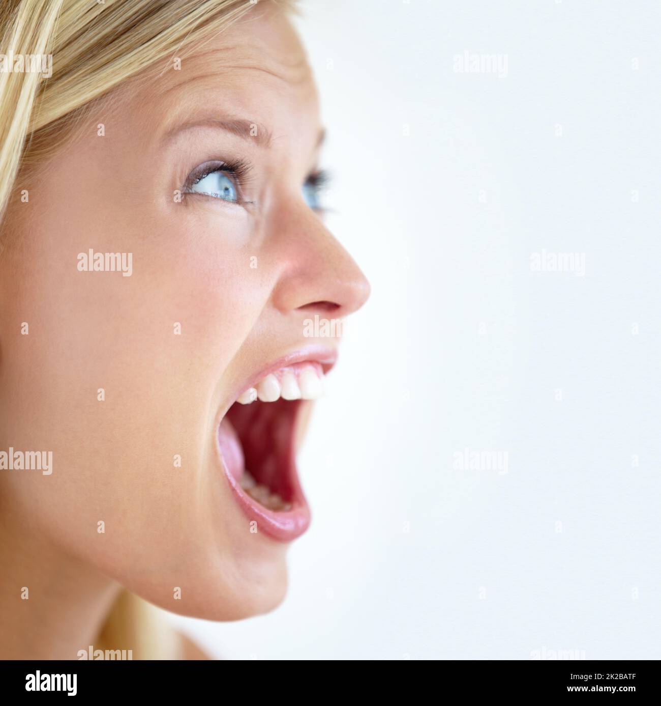 Look out. Closeup of a pretty young blonde screaming at somebody to watch out. Stock Photo