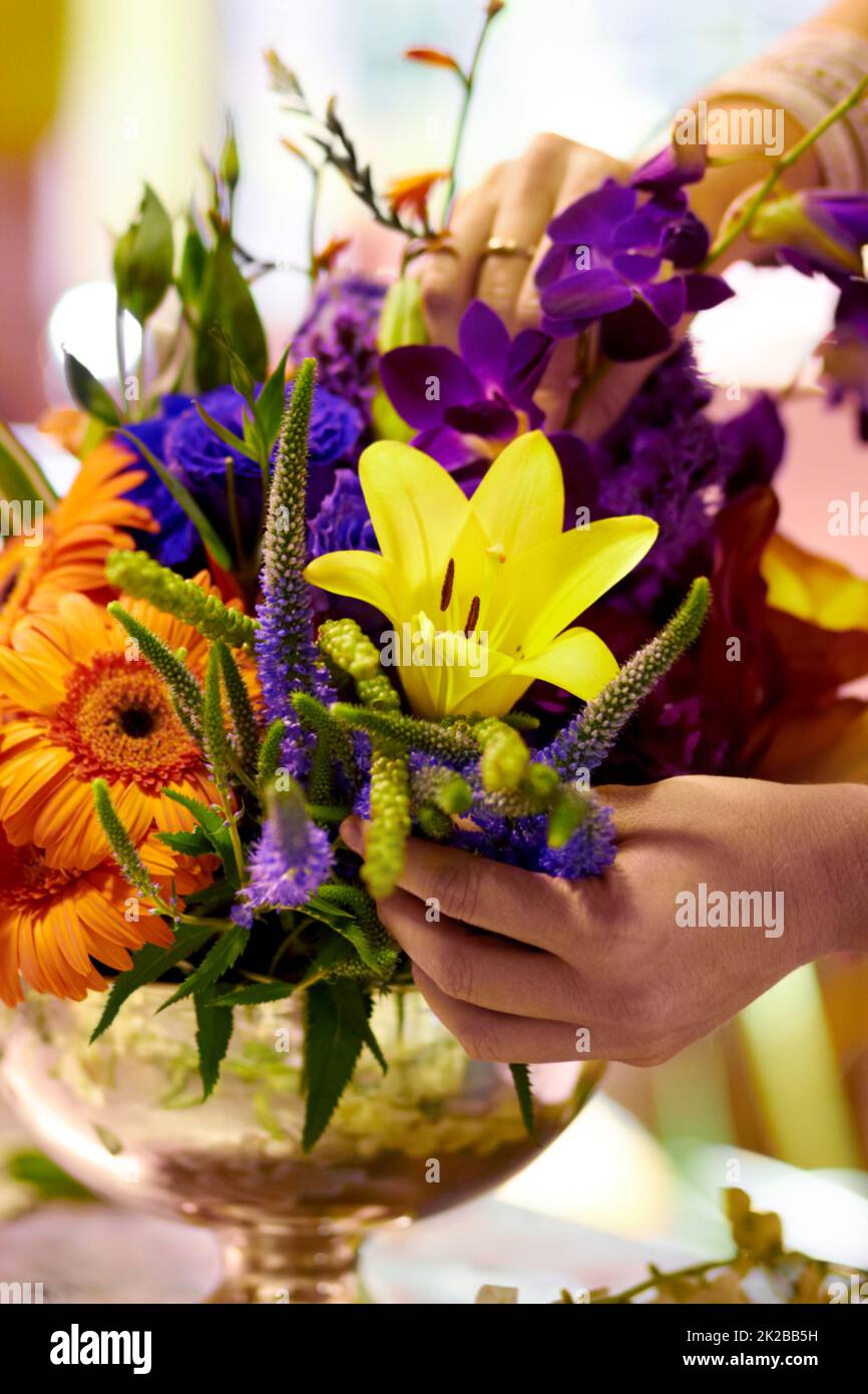 Bouquet of beauty. Closeup shot of a florists hands arranging a colourful bouqet. Stock Photo