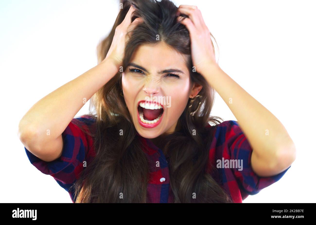 Ive reached my breaking point. Studio shot of a young woman shouting against a white background. Stock Photo