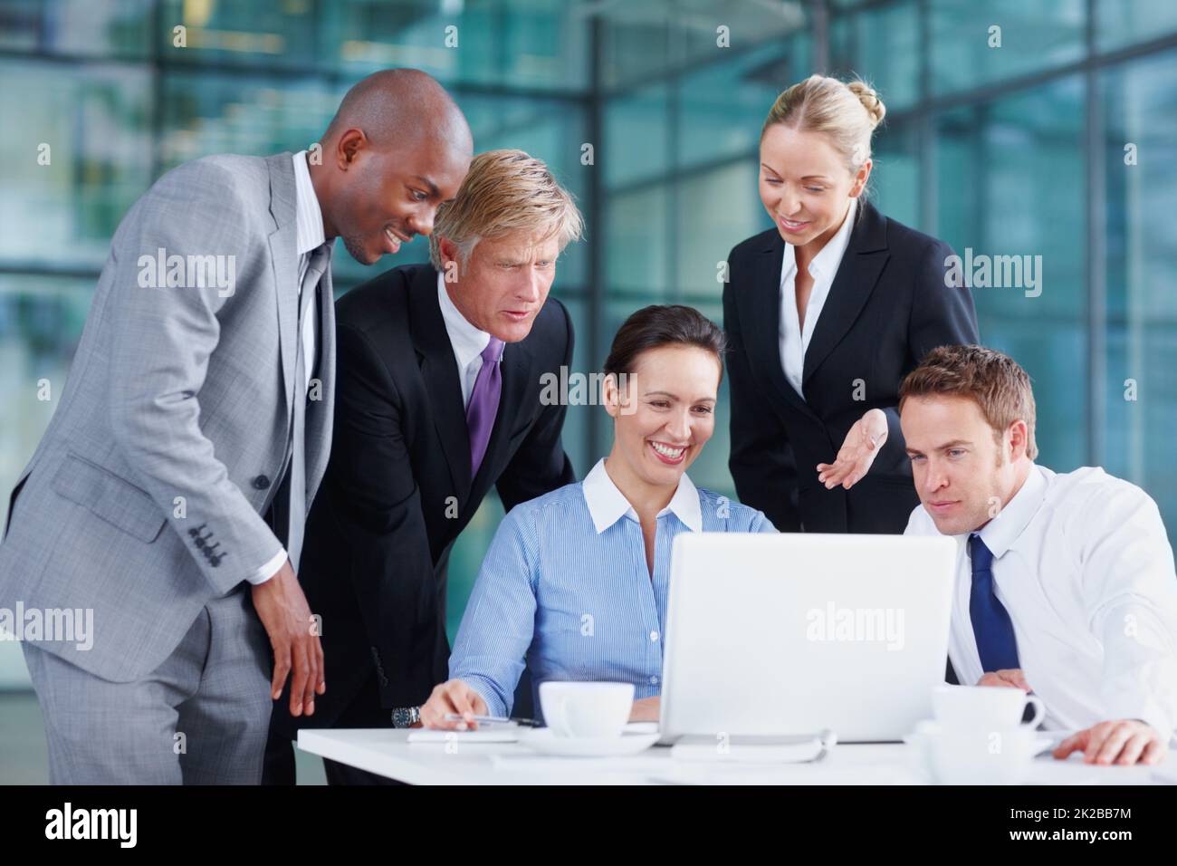 Looking at their latest stock reports. Positive team of business associates working together. Stock Photo