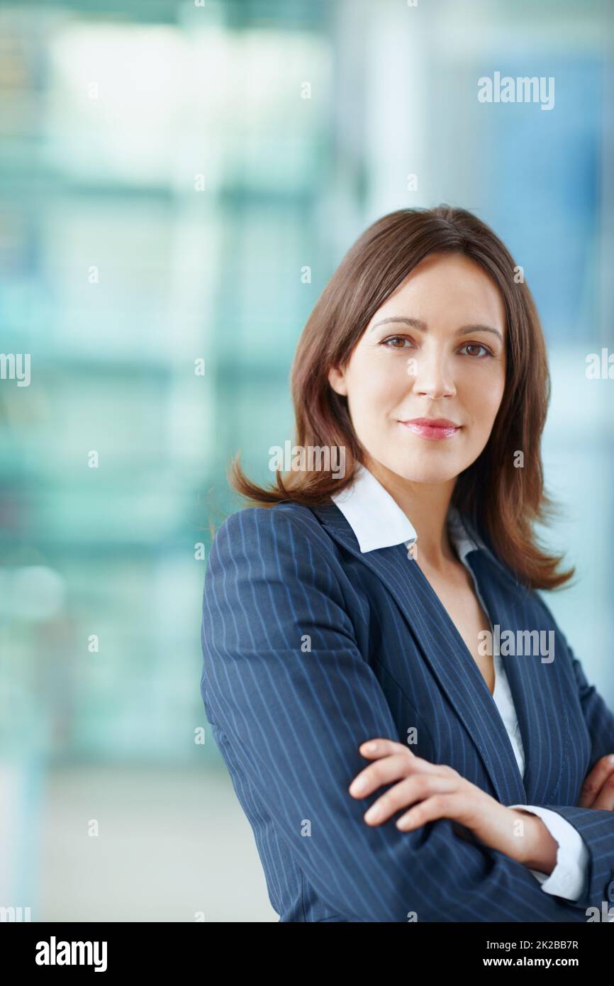 Her career is only going up. Attractive female business executive standing at work. Stock Photo