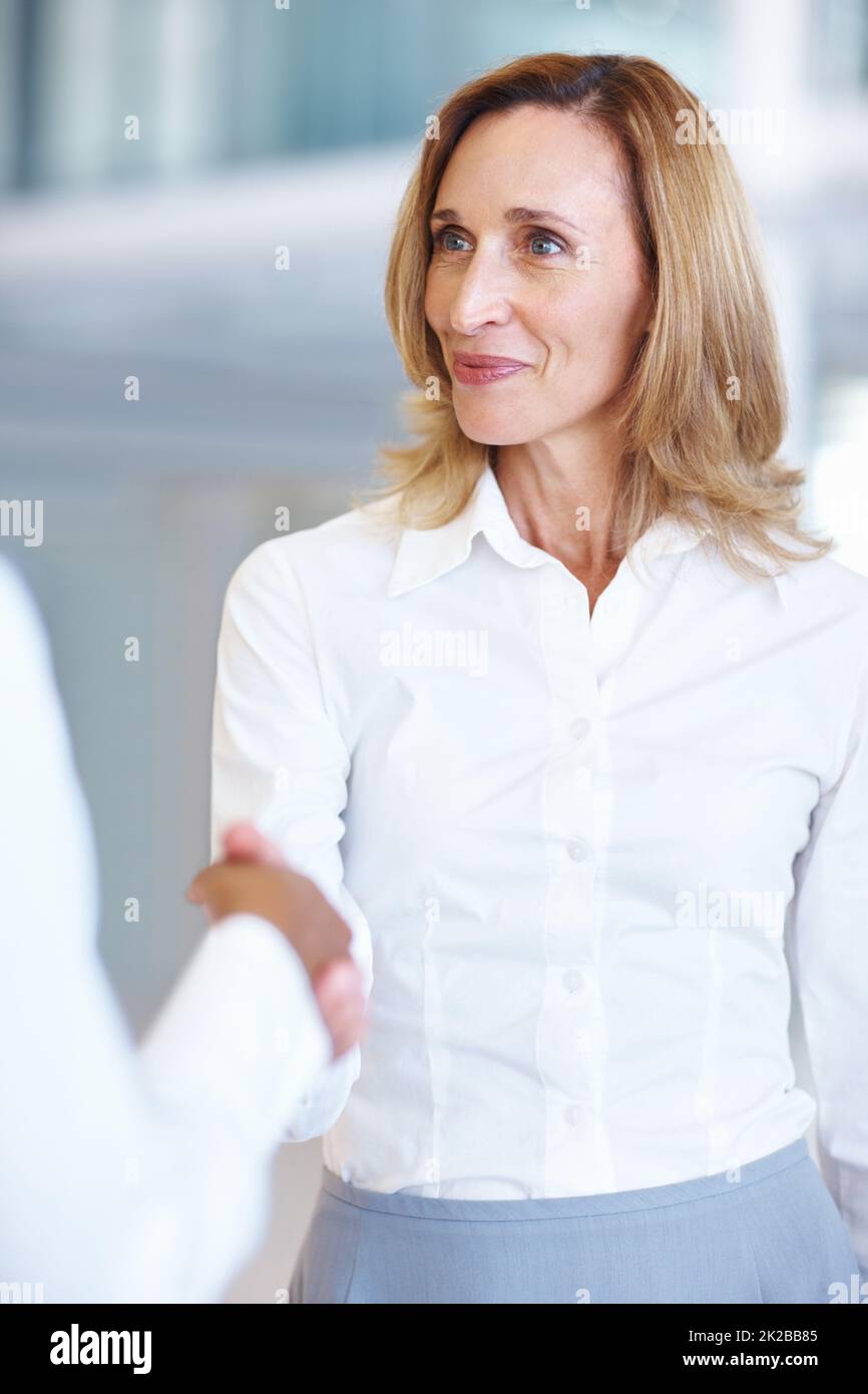 Sealing the deal. Portrait of mature business woman shaking hands with