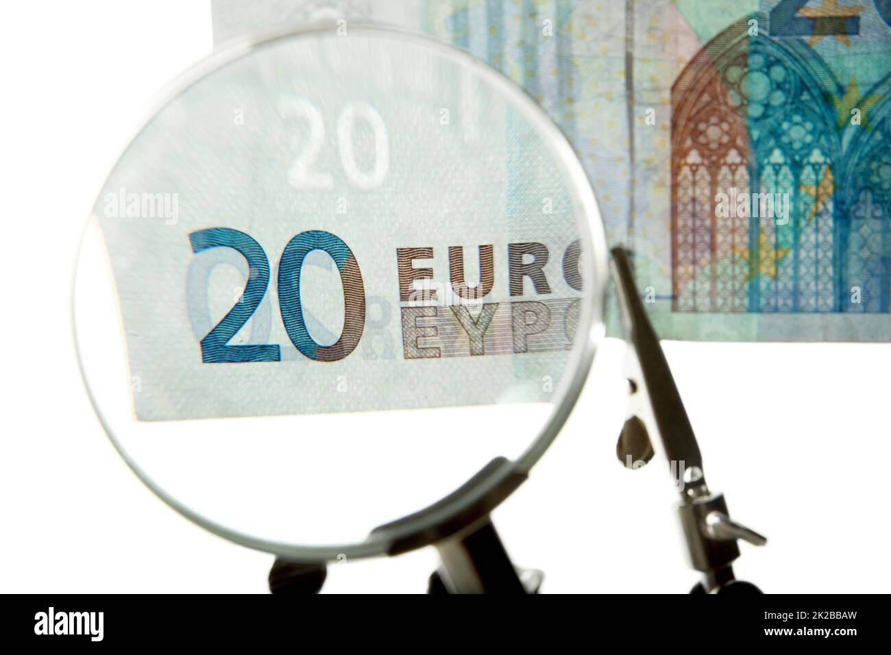 Checking every euro. Shot of a 20 euro bill under a magnifying glass. Stock Photo