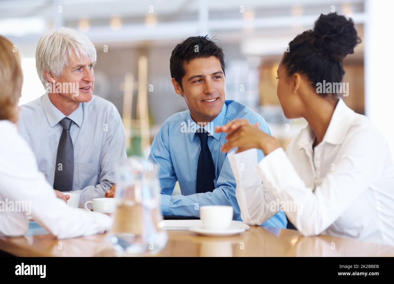 Multi ethnic business group discussing. Portrait of multi racial business group discussing at seminar room. Stock Photo