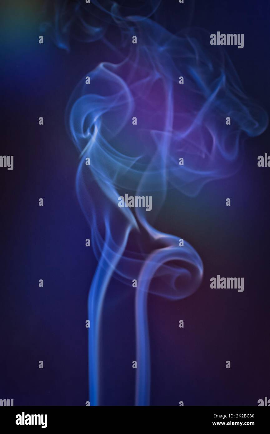 Smoky clouds on blue and black background Stock Photo