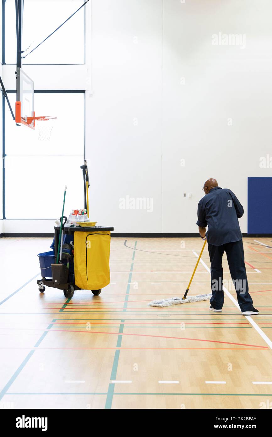 Cleaner working in school gymnasium Stock Photo Alamy