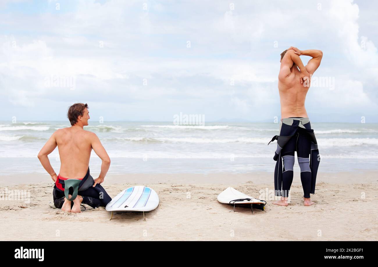 Surfing is a lifestyle. Young surfers enjoying a day out on the beach in the summertime. Stock Photo