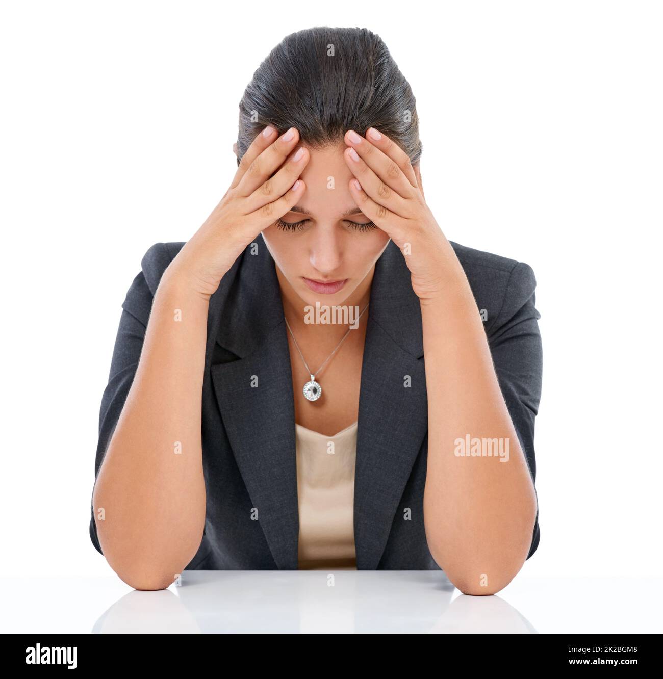 Too..much...stress. Studio shot of a stressed out businesswoman isolated on white. Stock Photo