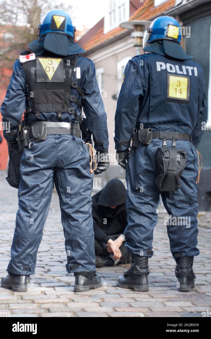 Making an arrest. Policemen apprehending a susect. Stock Photo