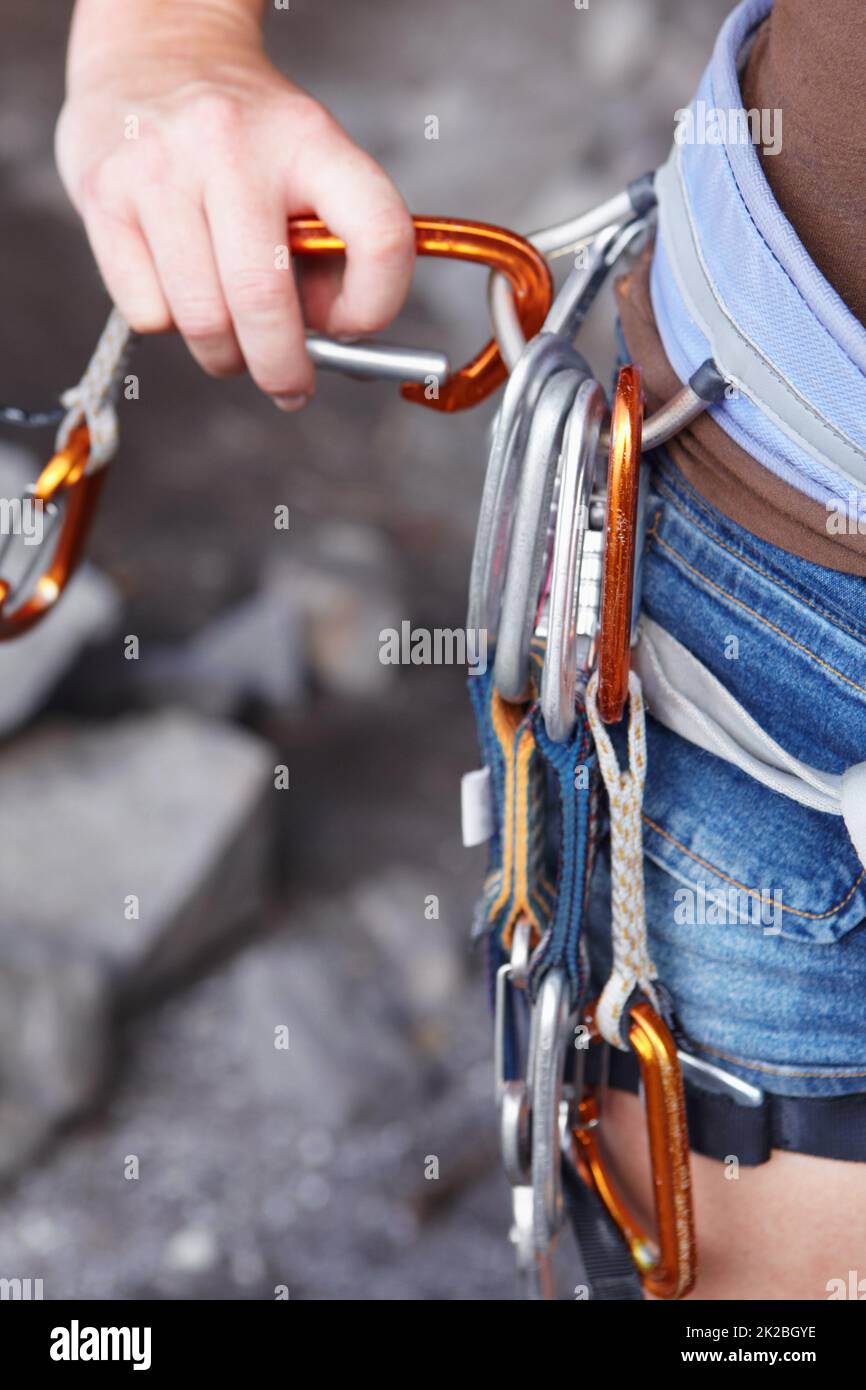 Attaching herself to the rope. A rock climbers hook with an assortment