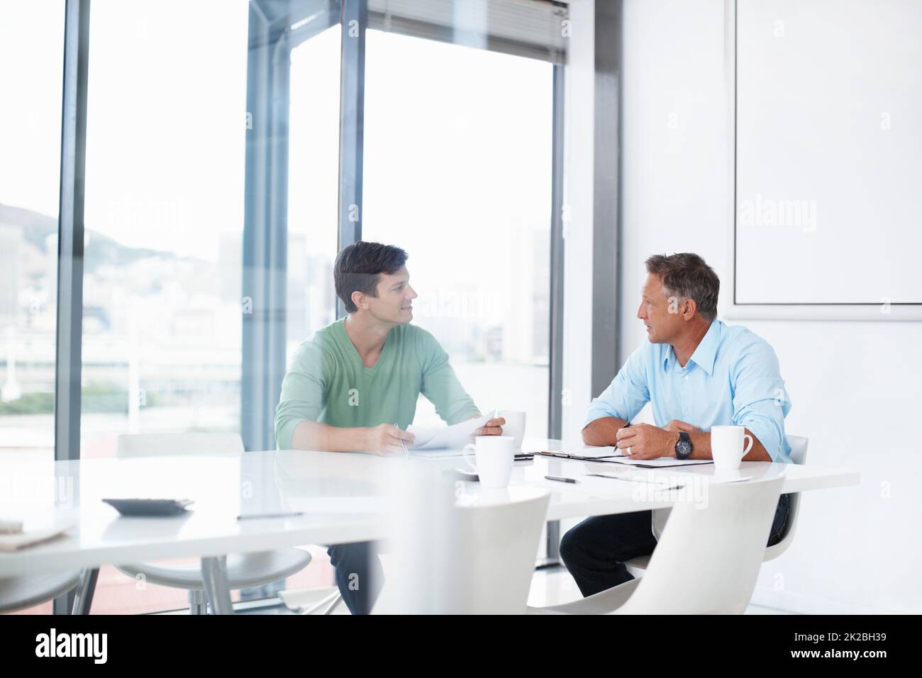 Making the pitch. A young advertising executive pitching an idea to his boss. Stock Photo