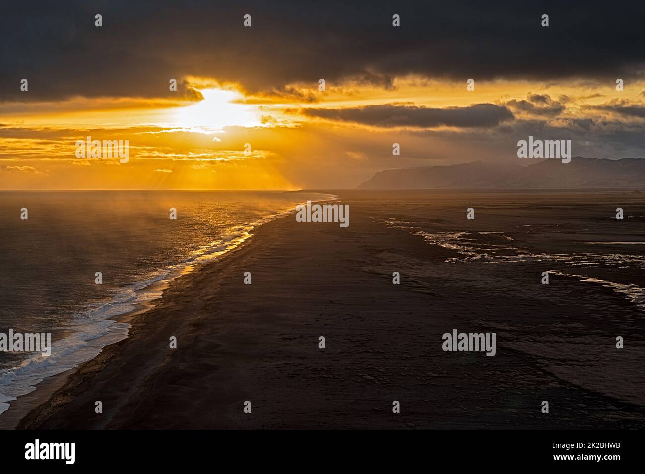 View of the black sand beach from Dyrholaey at sunset, Iceland Stock Photo