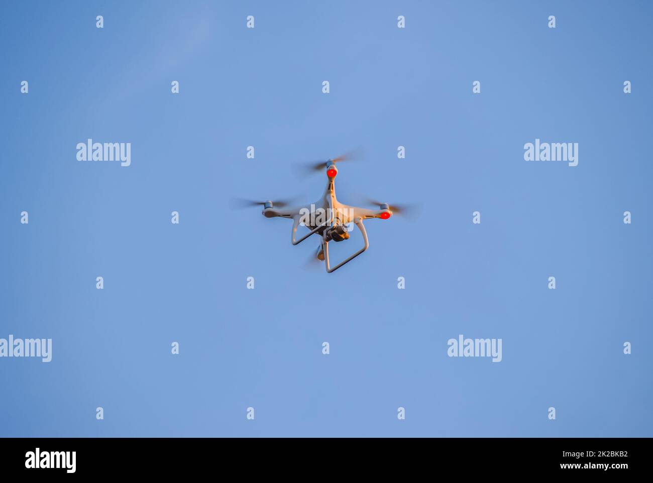 The drone, hovering in the sky. Flight quadrocopters Stock Photo
