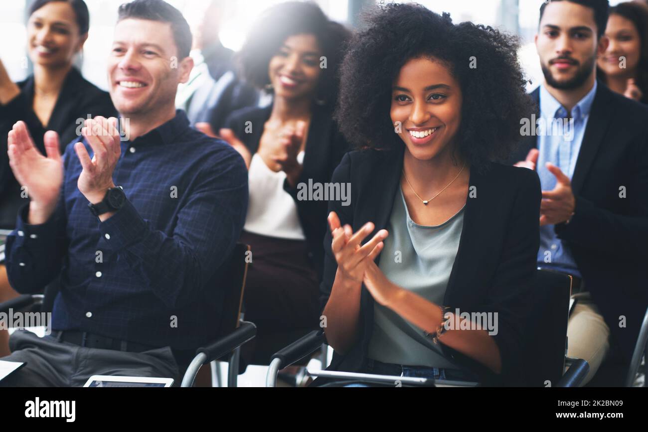 When you know youve reached everyone in the room. Shot of a group of businesspeople clapping while attending a conference. Stock Photo