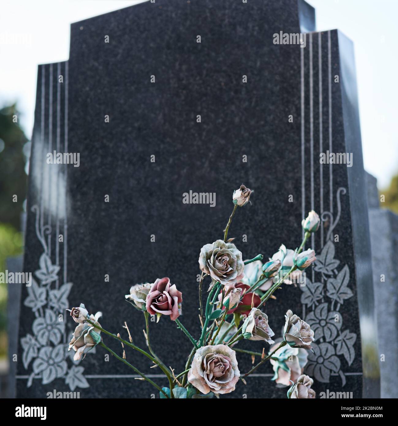 An eternal expression of love and remembrance. Shot of a gravestone in a cemetery. Stock Photo