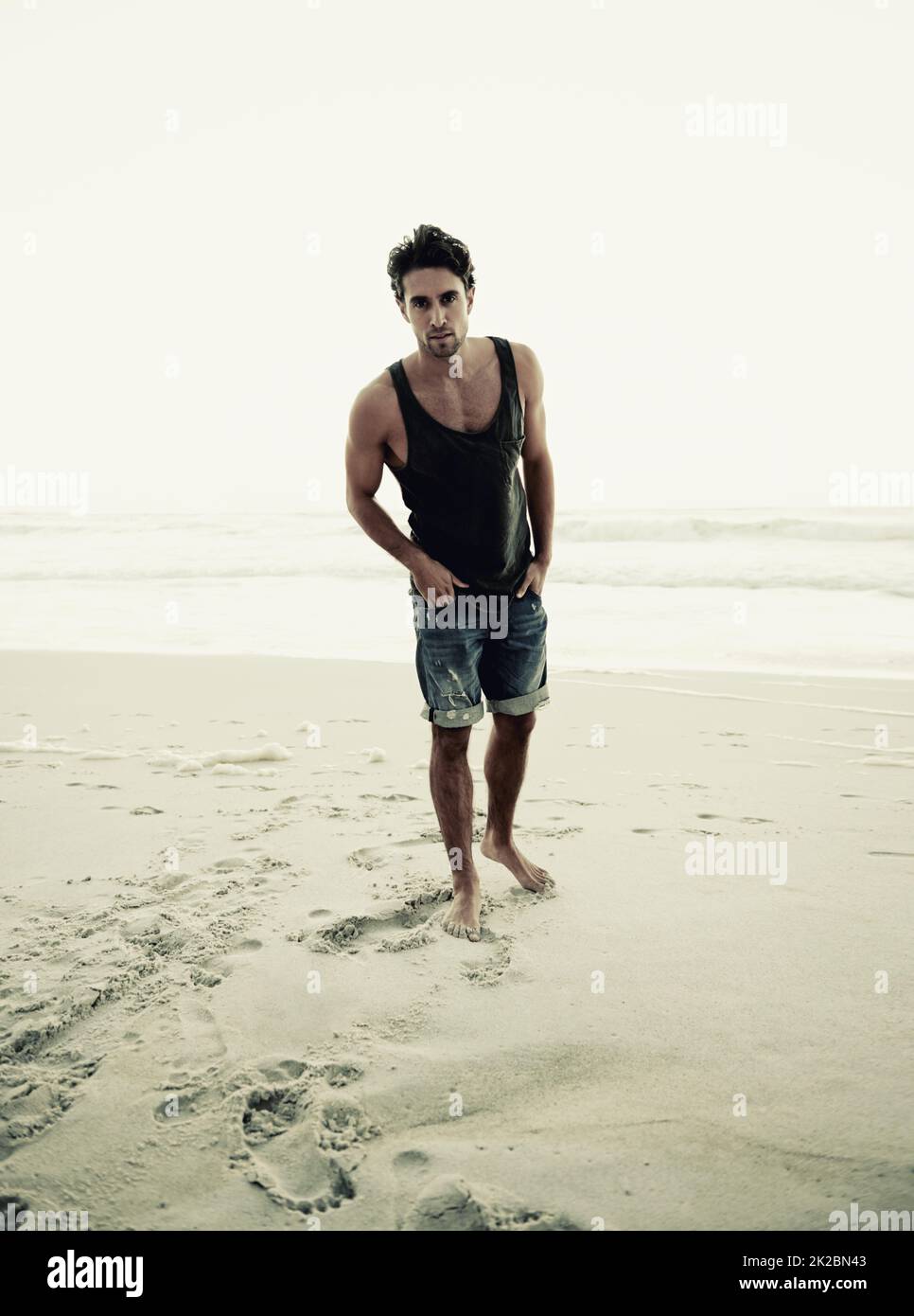 Theres no better place to relax. Cropped shot of a handsome young man on the beach. Stock Photo