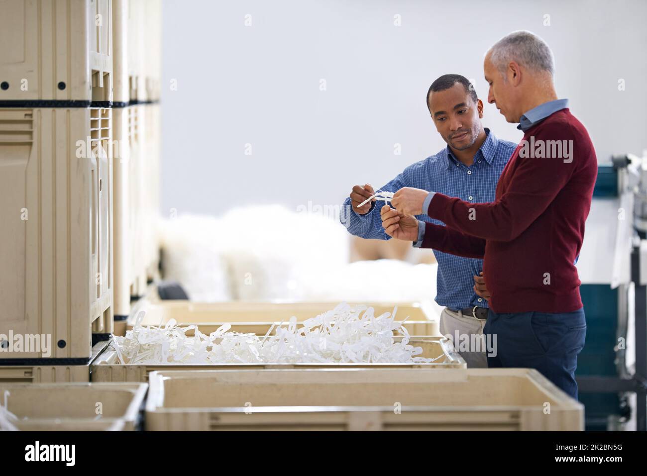 Stock control is vitally important. Shot of two factory managers doing an inspection of raw materials. Stock Photo