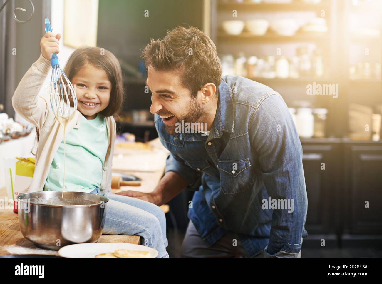 This is how you make the perfect pancake batter. Shot of a father and daughter making pancakes together. Stock Photo