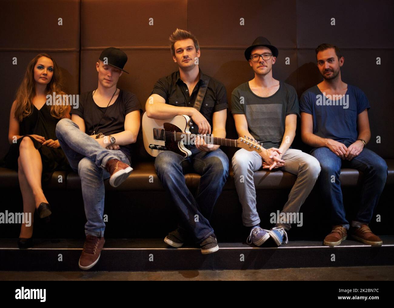 A band posing for a photo before a big show. This concert was created for the sole purpose of this photo shoot, featuring 300 models and 3 live bands. All people in this shoot are model released. Stock Photo