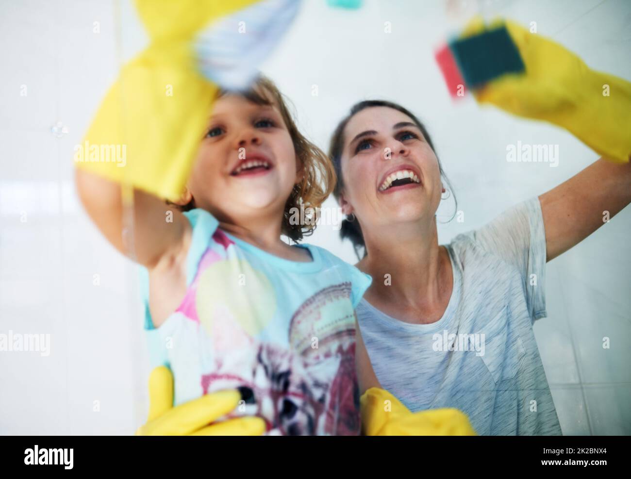 Making chores fun. Shot of a mother and daughter doing chores together at home. Stock Photo