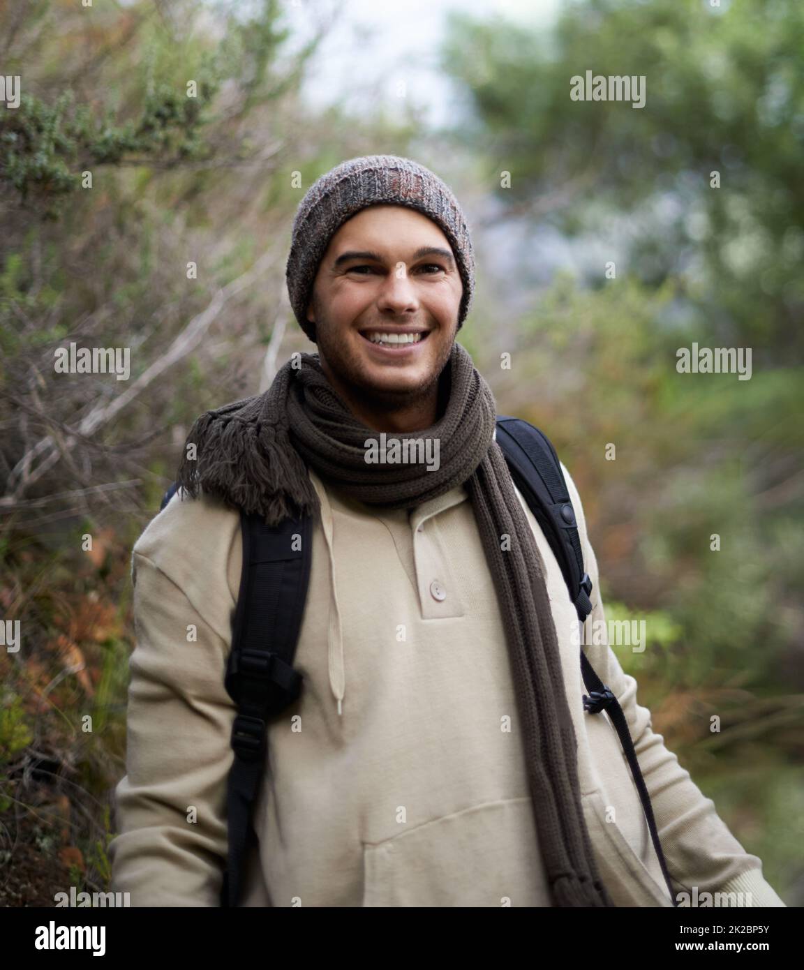He loves getting in touch with nature. Portrait of a handsome young man hiking in the mountains. Stock Photo