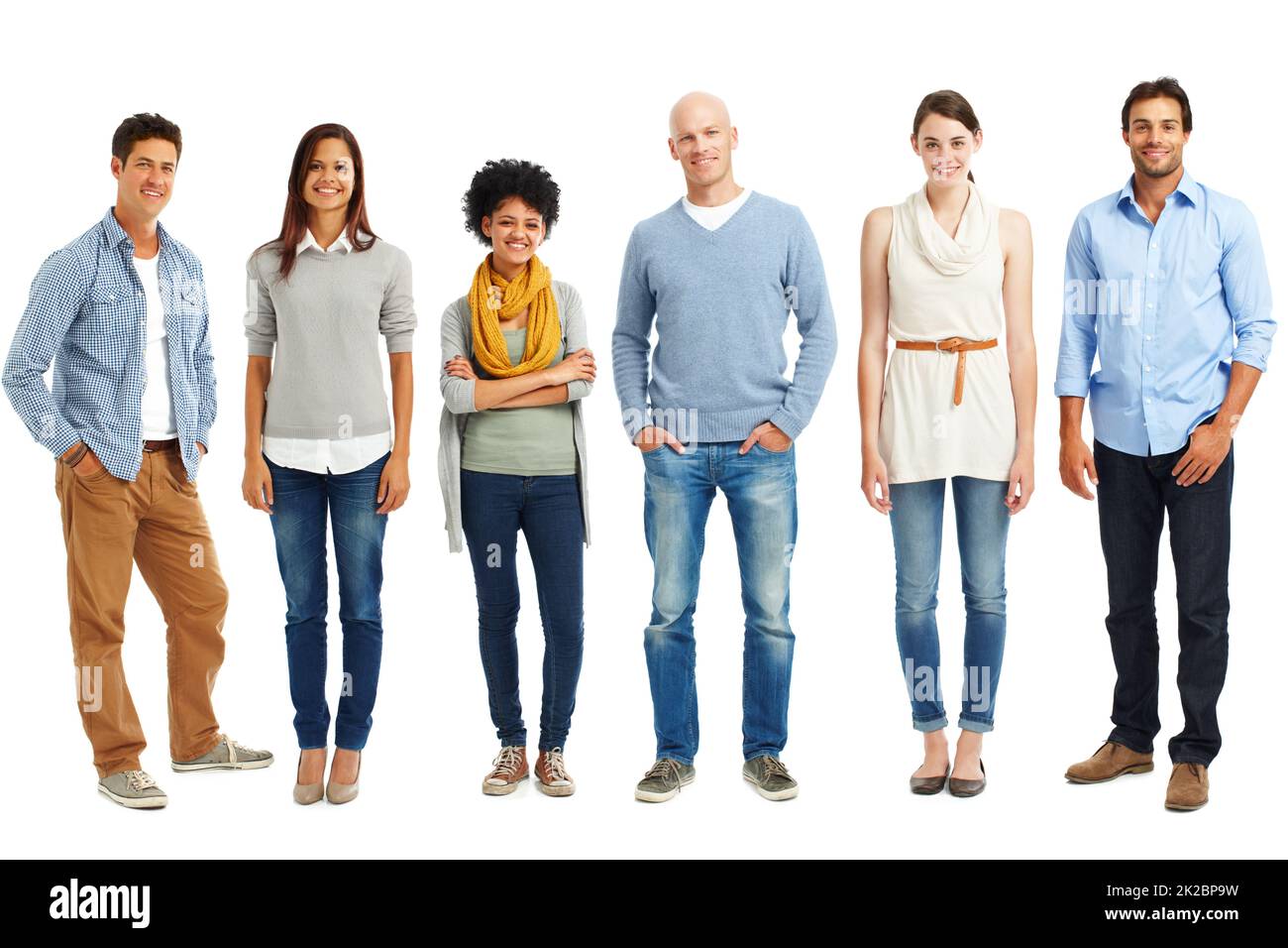 Stylish and casual line-up. Casually dressed group of young adults standing against a white background. Stock Photo