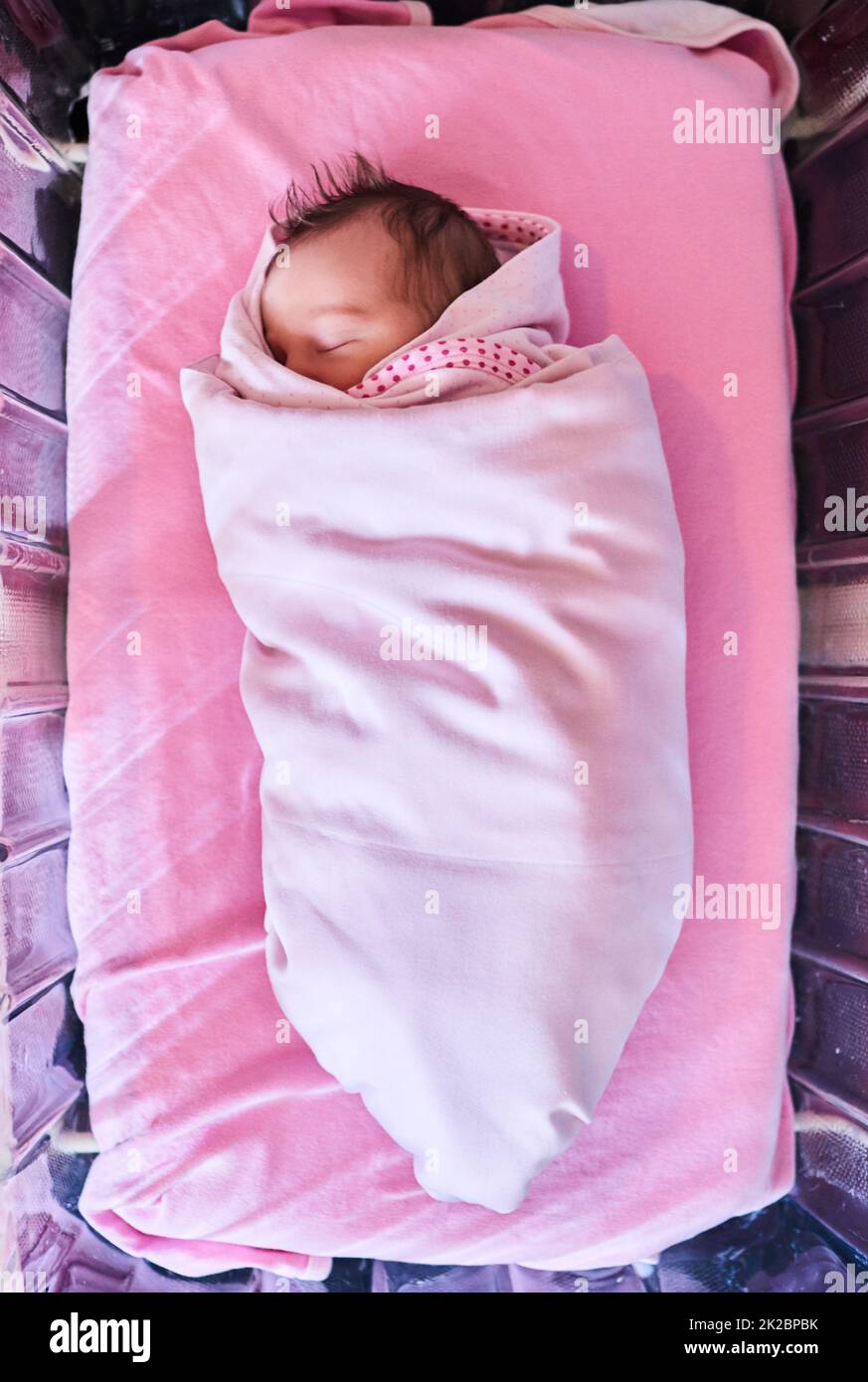 Sweet dreams little one. High angle shot of a newly born baby girl wrapped in a blanket in the hospital. Stock Photo