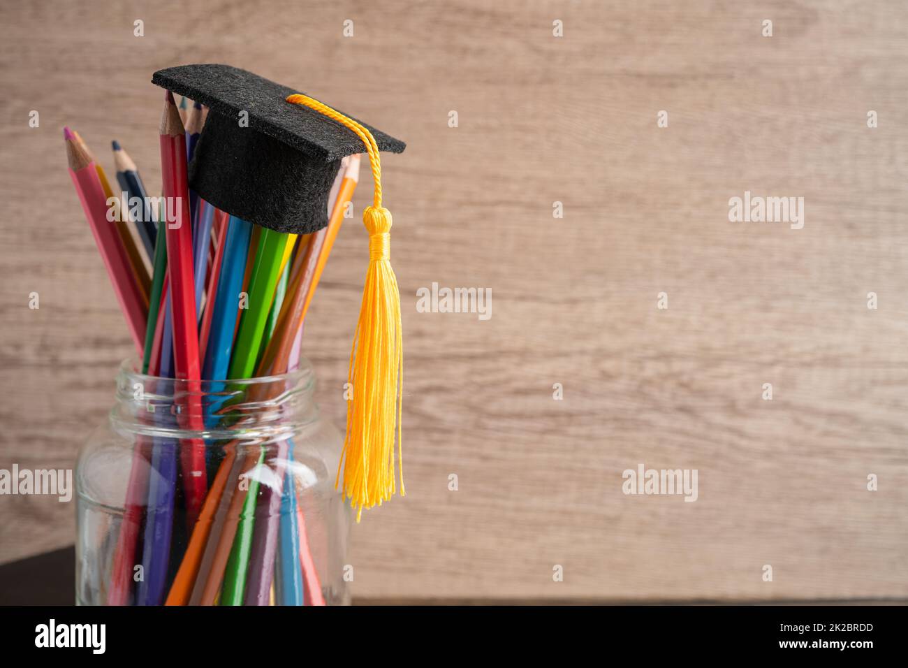 Graduation hat with colorful pencils with copy space, learning university education concept. Stock Photo