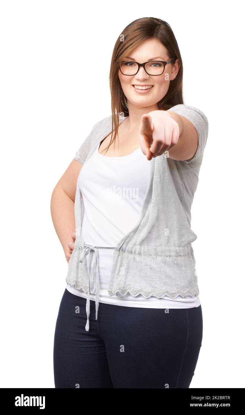 Pressing a digital interface. Studio portrait of a pretty plus-size model pointing at the camera isolated on white. Stock Photo