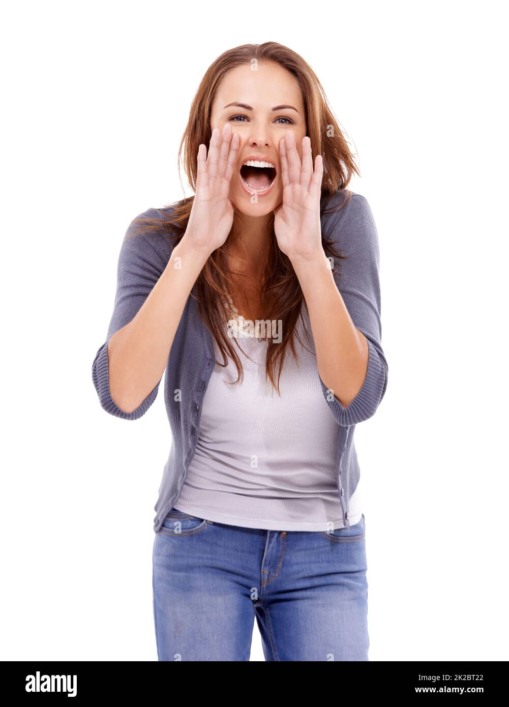 Hey over there. Casually dressed woman yelling loudly isolated on white. Stock Photo