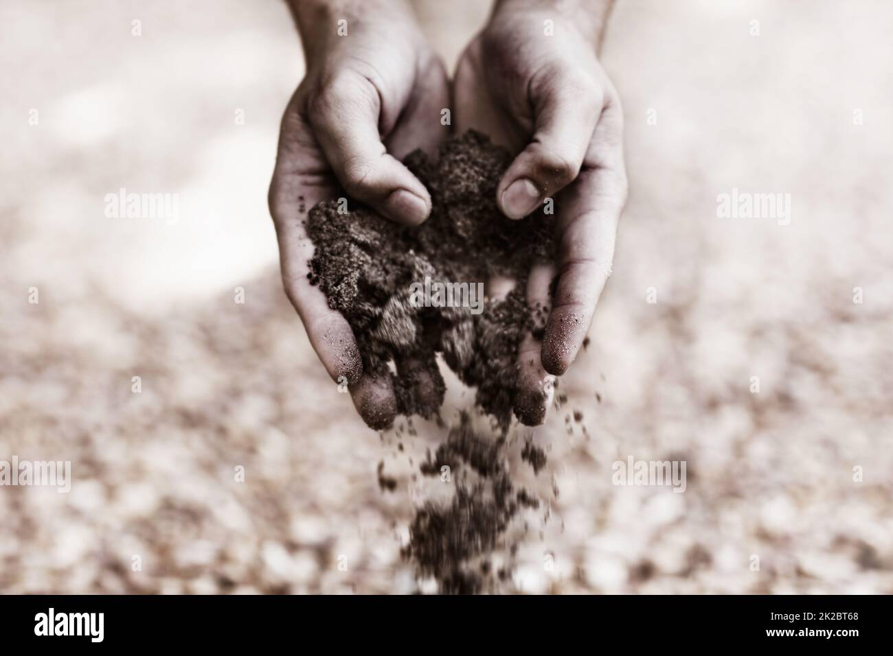 Returning the earth. Two hands holding dirt. Stock Photo